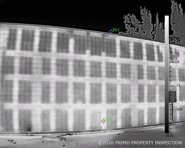 Infrared thermal scan of a CMU exterior wall showing temperature banding across the block coursing, used to identify missing grout invisible to the eye