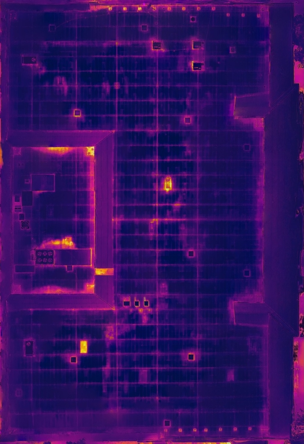 Infrared thermal scan of the same roof area, showing warmer tones over zones of suspected trapped moisture